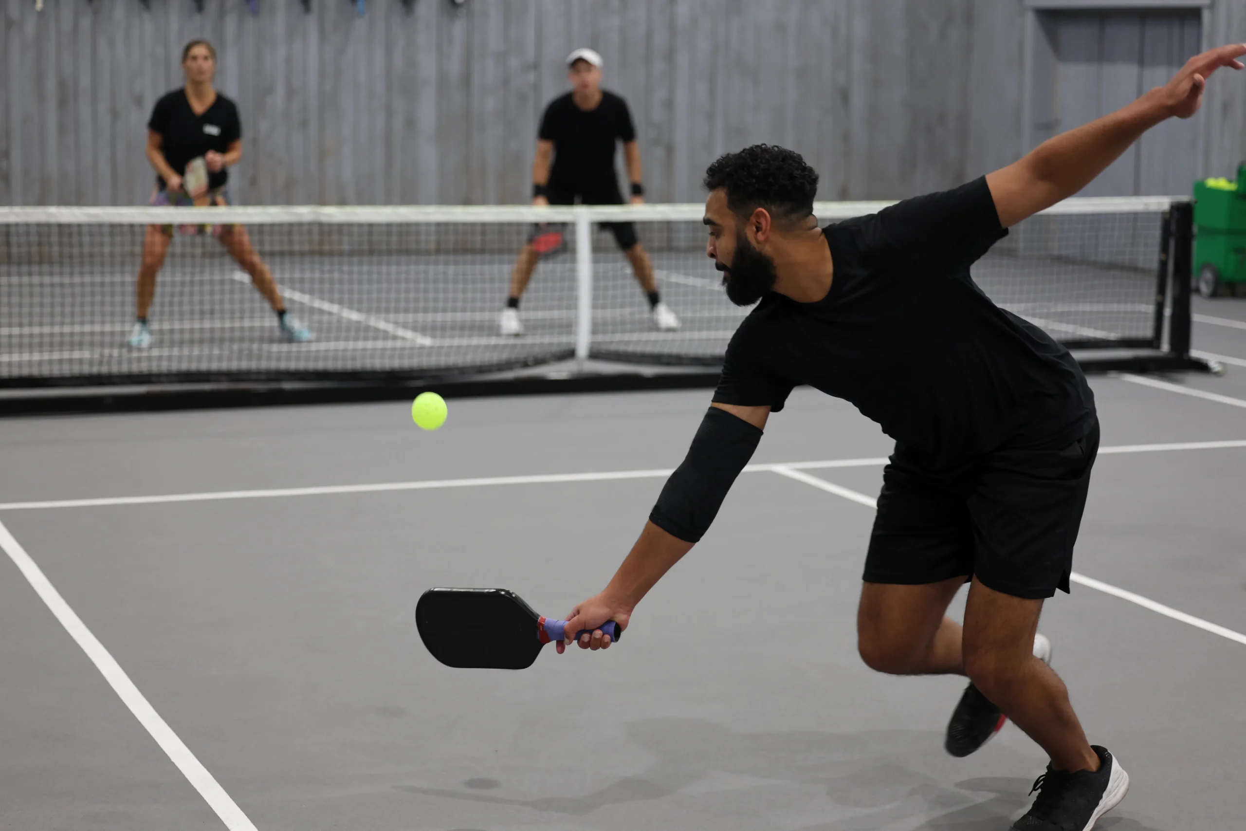 man playing pickle ball without injury after a successful physical therapy program